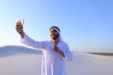 Wall Mural - Portrait of Arabian sheikh man with gadget that communicates in 