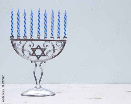 Fotografía Hanukkah Menorah with a Simple Blue Background on a Distressed Wooden Table
