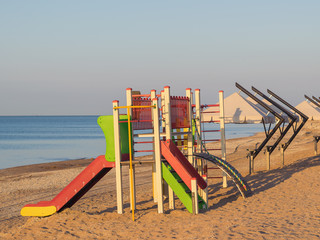 Colorful slide for children to play on the beach.