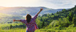 © sergo321 - The girl raised her hands and stands on a meadow in the mountains in the summer