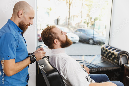 Male Professional Hairdresser Serving Client By Protective Tape