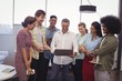 © WavebreakMediaMicro - Male manager showing laptop to colleagues in creative office
