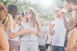 © chika_milan - Group of people talking and drinking while standing at outdoor party