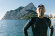 © ADDICTIVE STOCK - Diver in wet suit standing on beach
