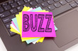 Writing Buzz text made in the office close-up on laptop computer keyboard. Business concept for Buzz Word llustration Workshop on the black background with copy space