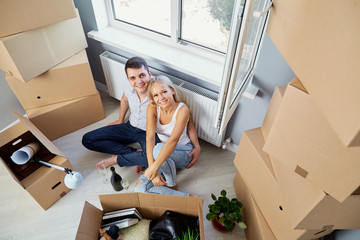 Young couple moving to a new apartment. Housewarming.