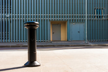 The Ashtray On Sidewalk On The Background Of Facade Of The Urban Parking Building With Steel Panels In A Row, Saint Petersburg, Russia
