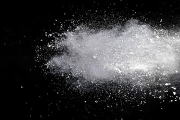 Splash of colorful powder over black background.