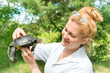 Pretty blond woman holding a turtle