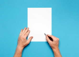 Male Hands Is Ready For Drawing With Pen, Top View On Blue Surface. Creativity Concept