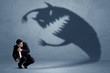 © ra2 studio - Business man afraid of his own shadow monster concept
