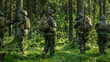 © Gorodenkoff - Squad of Five Fully Equipped Soldiers in Camouflage on a Reconnaissance Military Mission, Rifles in Firing Position. They're Moving in Formation Through Dense Forest. Back View Shot.