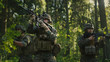 © Gorodenkoff - Three Fully Equipped Soldiers Wearing Camouflage Uniform Attacking Enemy, They're in Shooting Ready Stance, Aiming Rifles. Military Operation in Action, Squad Standing in Dense Forest.
