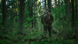 © Gorodenkoff - Shot of a Fully Equipped Soldier Moving Further in the Dense Forest. He's on the Reconnaisance Military Mission. Low Angle Footage.