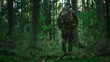 © Gorodenkoff - Shot of a Fully Equipped Soldier Moving Further in the Dense Forest. He's on the Reconnaisance Military Mission. Low Angle Footage.