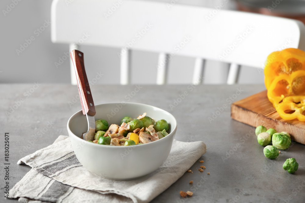 Bowl with yummy brussel sprouts salad on table