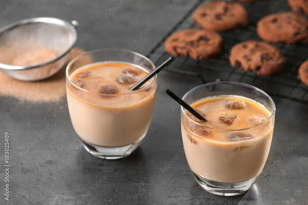Glasses with delicious iced coffee on table