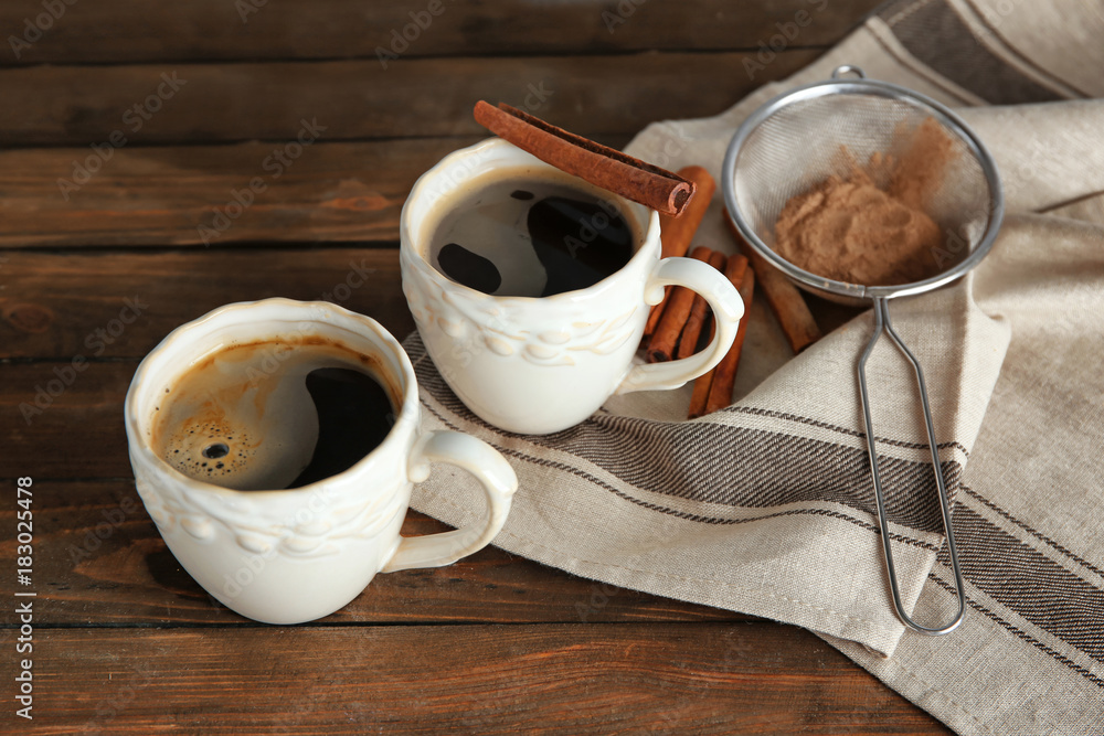 Ceramic cups with delicious coffee on table