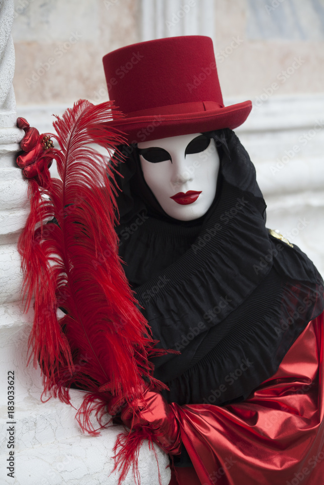 Person at Venice Carnival dressed in Venice mask and black and red ...