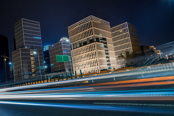 Wall Mural - light trails through the bridge in the downtown district, china.