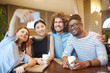 © pressmaster - Young intercultural students or managers making selfie in cafe while sitting by table at coffee-break