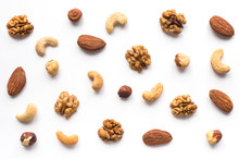 Isolated Nuts Pattern Backdrop. Walnut, Cashew, Almond And Hazelnut On White Background. Top View. 