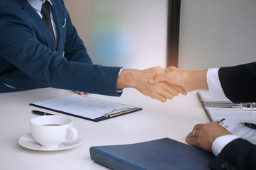 Businessman shaking hands successful candidate at interview. got the job in the team. Welcome aboard