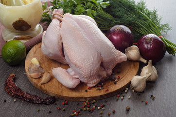 Fresh raw chicken composition on wooden background