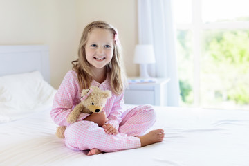 Wall Mural - Kids in bed. Children in pajamas. Family bedroom.