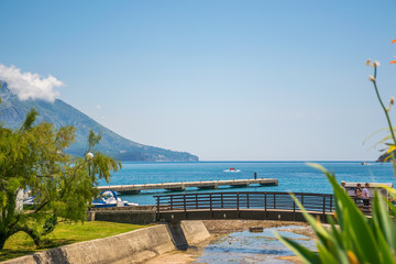 Wall Mural - MONTENEGRO, BUDVA - MAY 30/2017: tourists walk along the embankment visiting the sights.