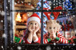 © famveldman - Child at Christmas tree. Kids at fireplace on Xmas