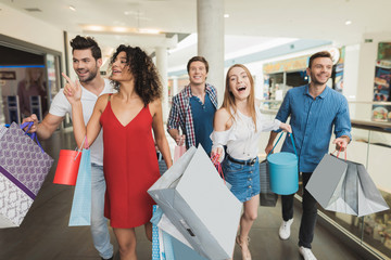 Sale in black Friday. The company of young people are engaged in shopping on a black Friday.