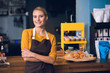 © Yakobchuk Olena - Portrait of happy young barista standing near table while having job in confectionary shop. Job concept