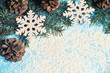 Christmas blue background with a pinecones and snow