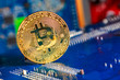 Golden Bitcoin Cryptocurrency on computer circuit board. Macro shot
