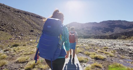 happy woman backpacker welcome you to travel and walk on new zealand in tongariro national park youn