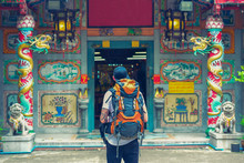 Backpacker Man In Chinese Temple In The Street Of Asia. Bangkok, Thailand.