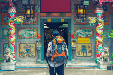 backpacker man in chinese temple in the street of asia. bangkok, thailand.