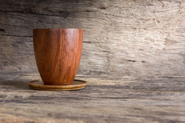 Wall Mural - real wooden cup and coaster with copy space for text. nature material utensil concept.