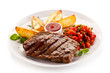 Grilled steak, baked potatoes and vegetable salad on white background 