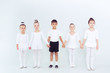 © uv_group - Group of kids boys and girls dancing at a white class room or studio smiling and hugging together