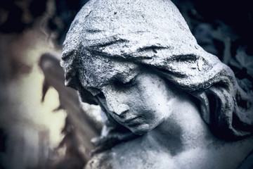  Close up of an ancient statue of guardian angel (vintage style photo)