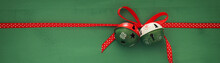 Christmas Background With Red Silk Traditional Ribbon And Jingle Bells.