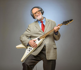 Senior man playing electric guitar