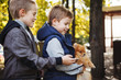 © olgasparrow - Funny little boys playing with the dog in the Park