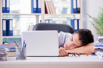 Tired exhausted businessman sitting in the office