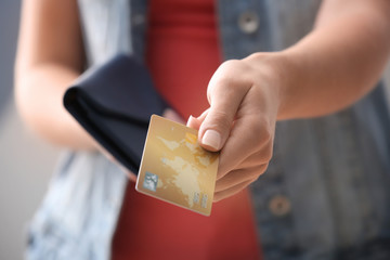 Wall Mural - Young woman with credit card and purse, closeup