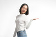 © SOMPHOTO - Beautiful young asian woman  pointing at whitespace