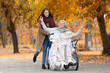© Africa Studio - Disabled senior woman and young caregiver in park