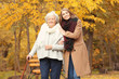 © Africa Studio - Senior woman with cane and young caregiver in park